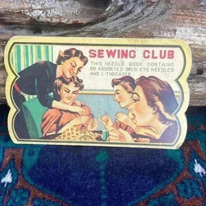 Vintage sewing club book with needles.